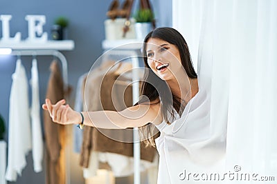 Woman in clothes store in changing room Stock Photo