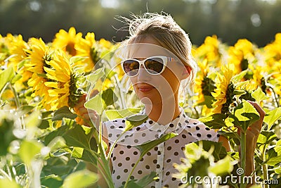 Woman clowns in the sunflowers Stock Photo