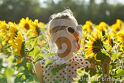 Woman clowns in the sunflowers Stock Photo