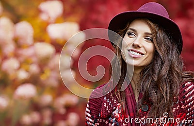 Woman in coat with hat and scarf in autumn park Stock Photo