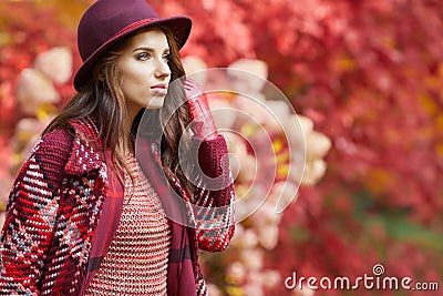 Woman in coat with hat and scarf in autumn park Stock Photo