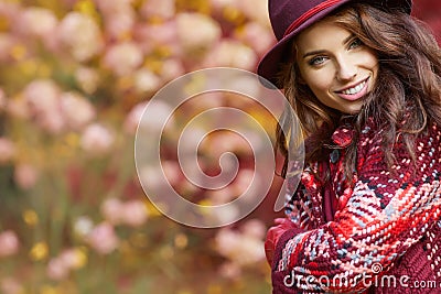 Woman in coat with hat and scarf in autumn park Stock Photo