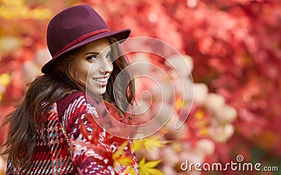 Woman in coat with hat and scarf in autumn park Stock Photo