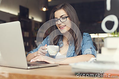 Woman with coffee using laptop Stock Photo
