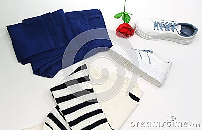 woman collection: blue jean and white sneakers with blue shoelaces and zebra woolen sweater. Stock Photo