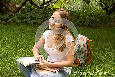 Woman college student with book studing in park Stock Photo