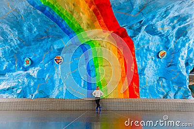Woman on colorful rainbow art at subway. Underground in Stockholm. Editorial Stock Photo