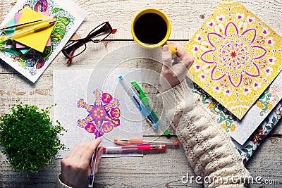 Woman coloring an adult coloring book, new stress relieving trend, mindfulness concept Stock Photo