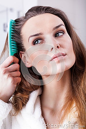 Woman combing hair Stock Photo