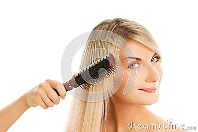 Woman combing her hair Stock Photo