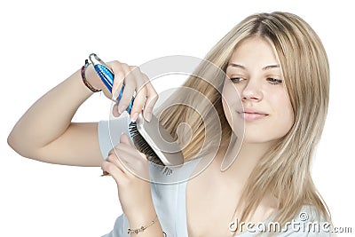 Woman combing her hair Stock Photo