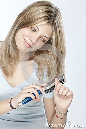 Woman combing her hair Stock Photo