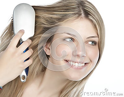 Woman combing her hair Stock Photo