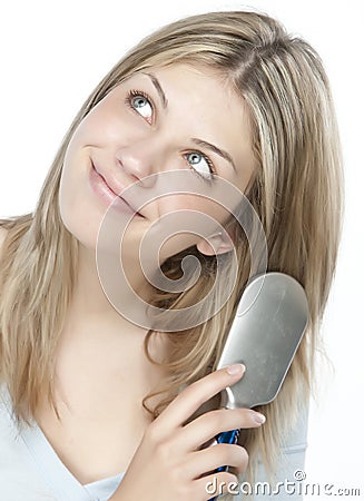 Woman combing her hair Stock Photo