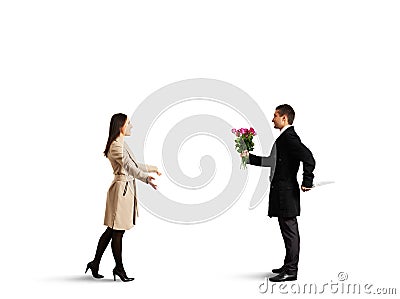 Woman coming to man with flowers and knife Stock Photo