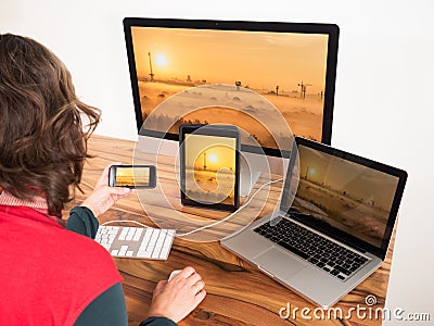 Woman with computers and mobile devices Stock Photo