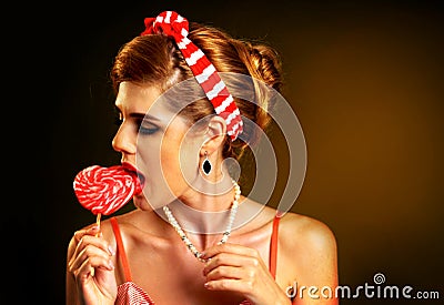 Woman confectioner seller tasting retro candy Stock Photo