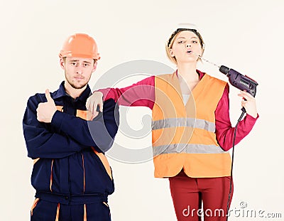 Woman with confident face in helmet, hard hat holds drill Stock Photo