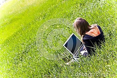 Woman connected on the grass Stock Photo