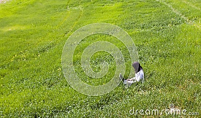 Woman connected on the grass Stock Photo