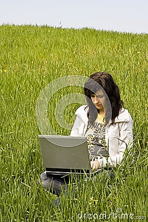 Woman connected on the grass Stock Photo