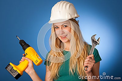 Woman with constructor helmet and tools happy to do tough work. Stock Photo