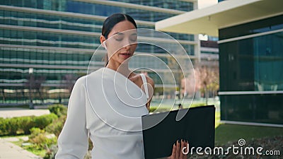 Woman consultant headphones walking to office talking close up. Chic girl call Stock Photo