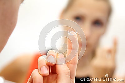 Woman with contact lens on her finger Stock Photo