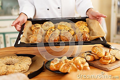 Woman cook with baked goods Stock Photo