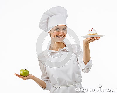 Woman cook chooses between an apple and a cake Stock Photo