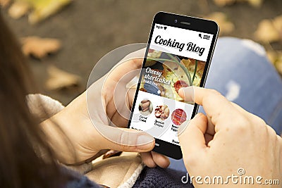 Woman with cooking blog phone in the park Stock Photo