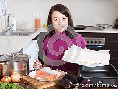 Woman cooking fish pie with store-bought dough Stock Photo