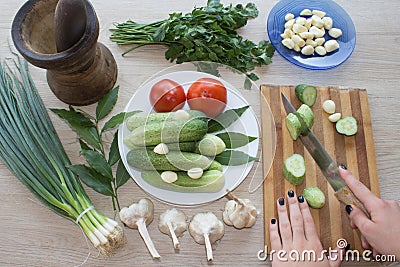 Woman cooking healthy meal in the kitchen. Cooking healthy food at home. Woman in kitchen preparing vegetables Stock Photo