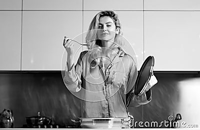Woman cooking in a kitchen. Sexy housewife on morning. Housework. Stock Photo