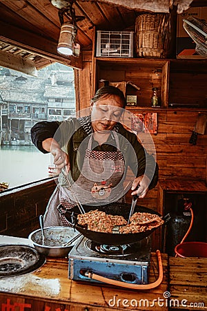 An woman cooking traditional pancake Editorial Stock Photo