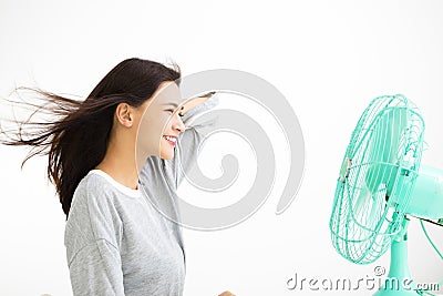 Woman cooling herself by electric fan Stock Photo