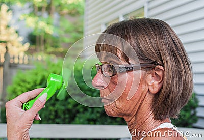 Woman Cools Herself Stock Photo