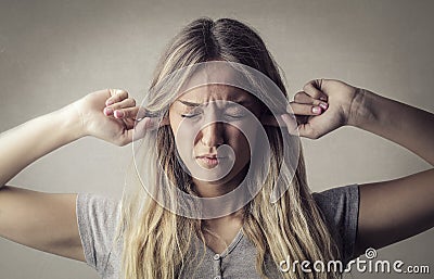 Woman covering ears Stock Photo