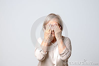 Woman covering eyes with her fingers Stock Photo