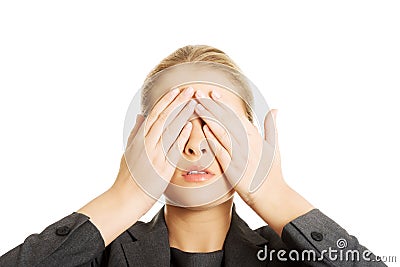 Woman covering her face with both hands Stock Photo