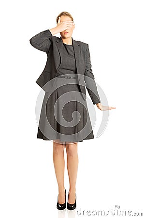 Woman covering her face with both hands Stock Photo