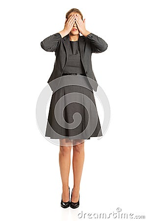 Woman covering her face with both hands Stock Photo