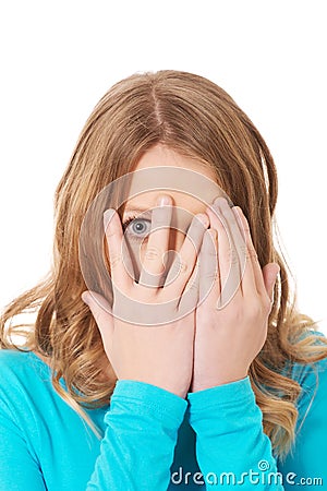 Woman covering her face with hands Stock Photo