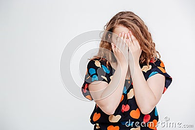 Woman covering her face with palms Stock Photo