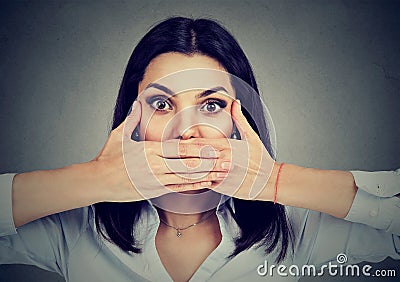 Woman covers her mouth with hands Stock Photo