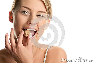Woman cracking walnut Stock Photo