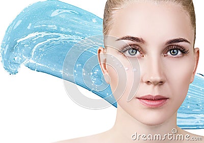 Woman with cream dots on face in blue water splash Stock Photo