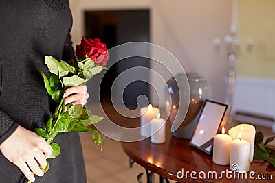 Woman with cremation urn at funeral in church Stock Photo