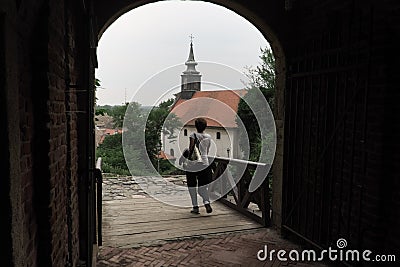 Woman Crosses Gate In Petrovaradin Fortress, Serbia Editorial Stock Photo