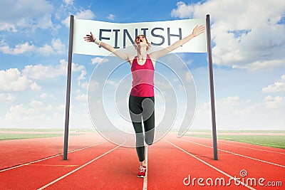 Woman crossing the finish line Stock Photo